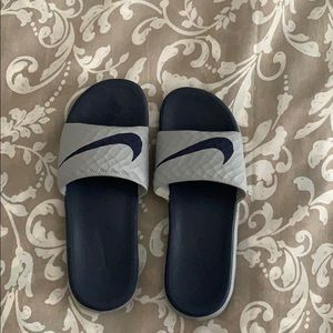 gray and navy nike slides. warn 4x